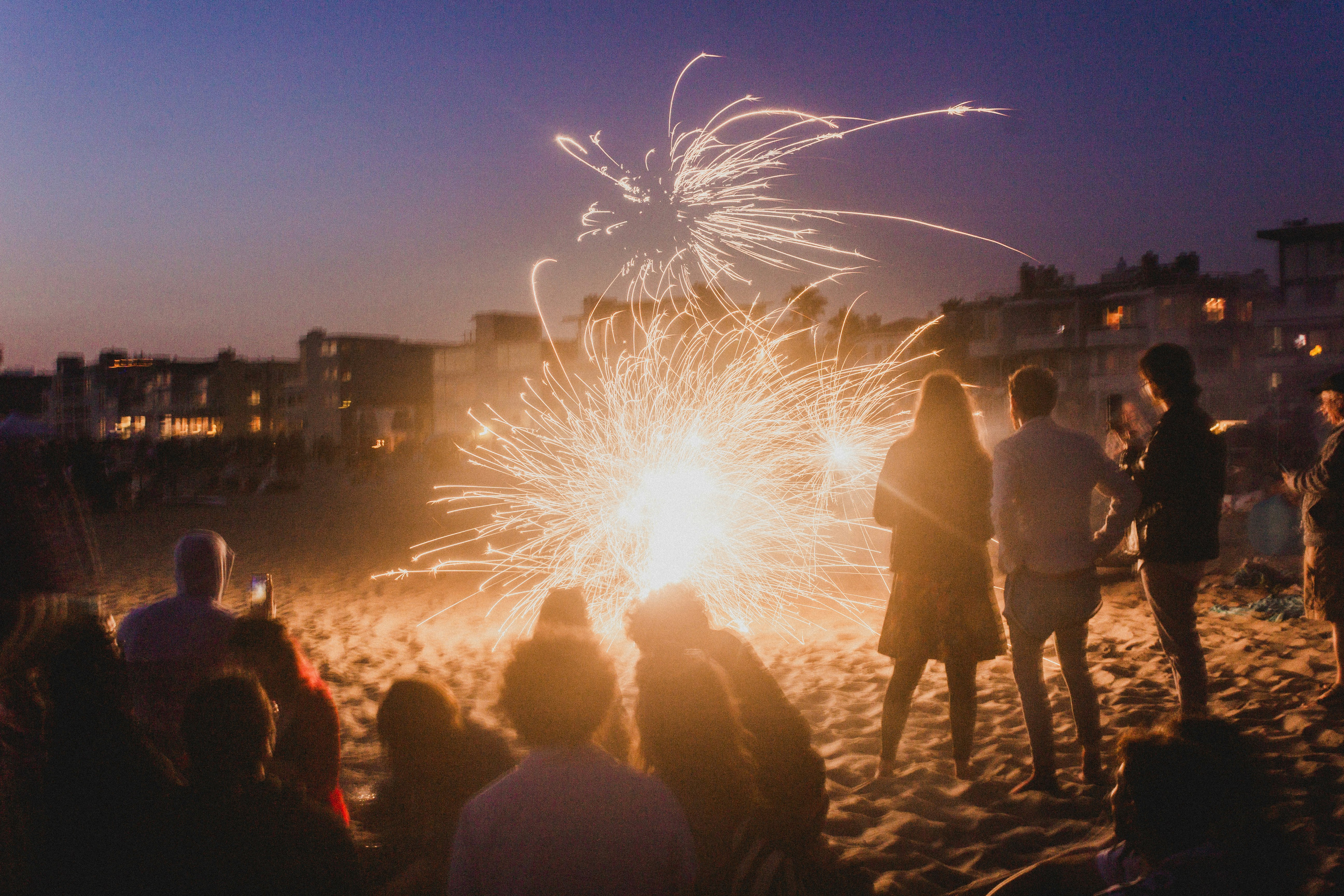 people watching fireworks display during night time